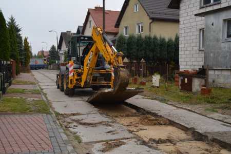 Koparka zdejmuje betonowe płyty, z których zbudowana była stara nawierzchnia ul. Jastruma