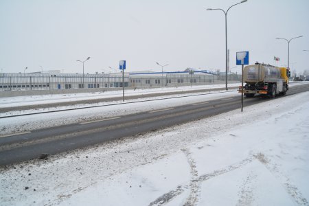 Zaśnieżona ulica Mleczarska, którą jedzie samochód ciężarowy